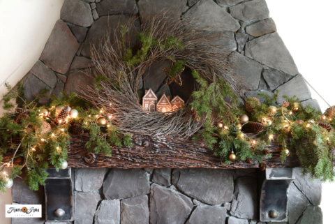 Christmas tour: evergreen branches with gingerbread village wreath on a Christmas mantel