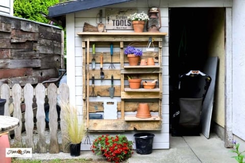 DIY pallet yard tool organizer with shelves and hooks